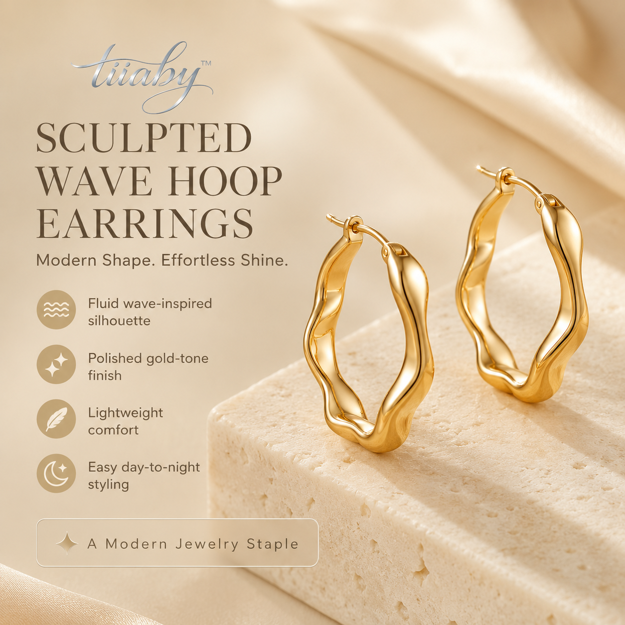 tiiaby sculpted wave hoop earrings in polished gold tone